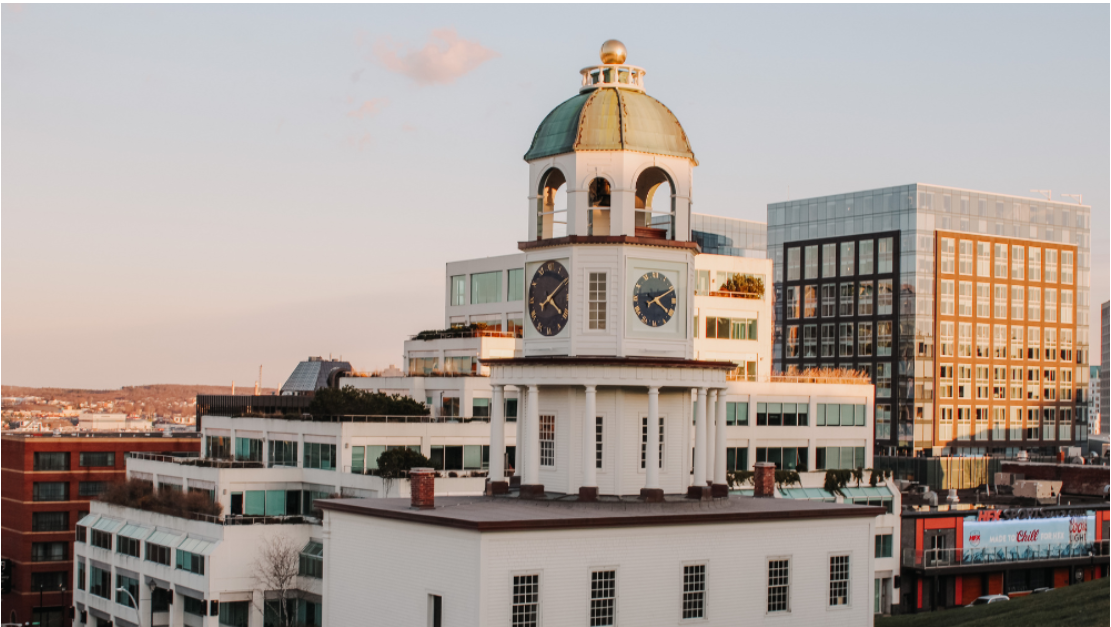 The historic Halifax Town Clock surrounded by modern buildings in downtown Halifax, Nova Scotia.