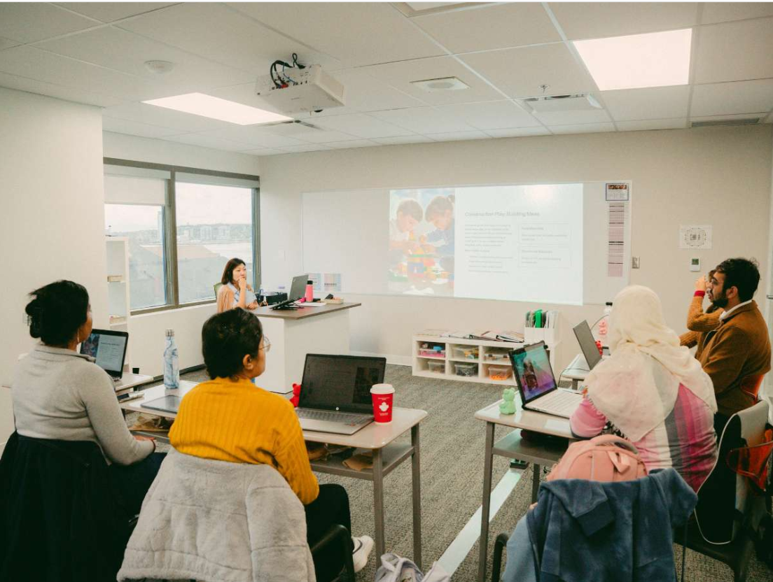 A diverse group of adult students attending an interactive classroom lesson in Halifax.