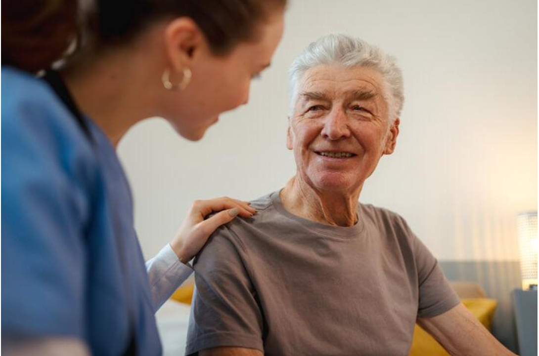 Continuing Care Assistant speaking with an older adult and providing emotional support and companionship.
