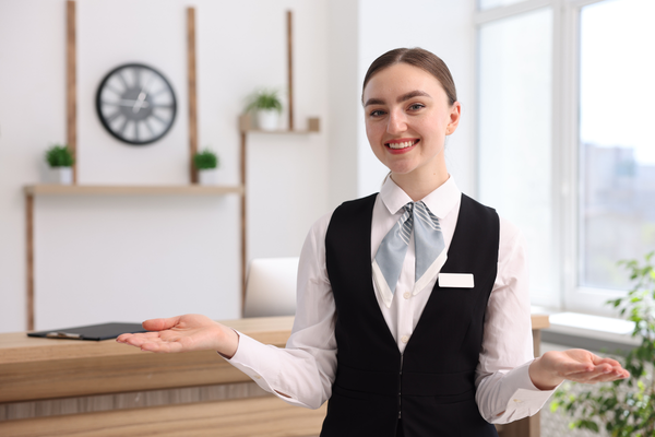 Hotel worker smiling. Study the Hospitality Management program at OICC in Vancouver