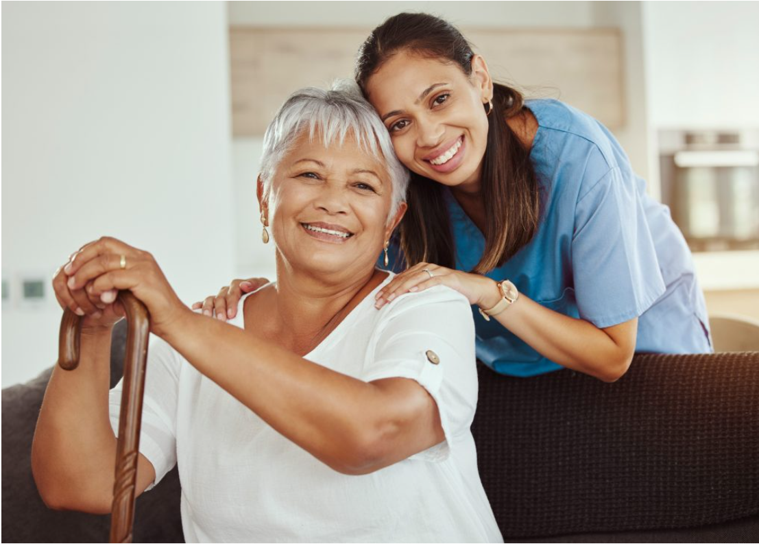 Continuing Care Assistant providing warm, compassionate support to an older adult in a home-care setting.