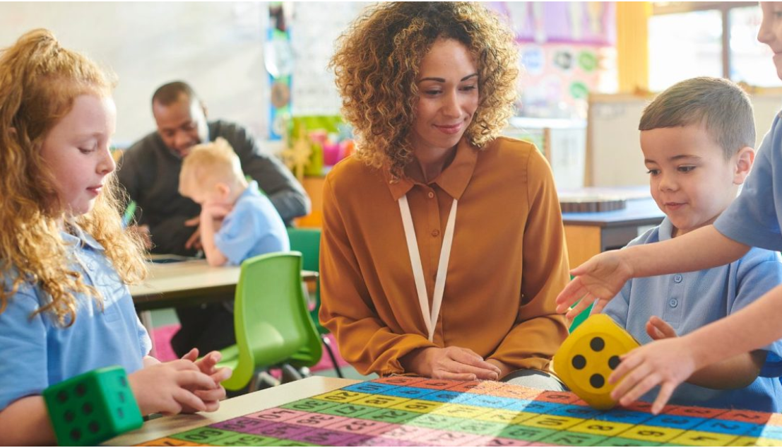 Early childhood educator guiding children through a colourful counting and number activity in a classroom.