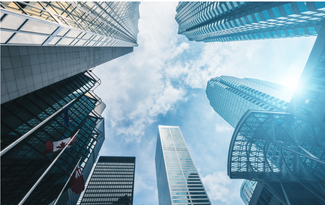 Modern office towers in a Canadian city viewed from below, representing professional opportunities and workplace culture in Canada.