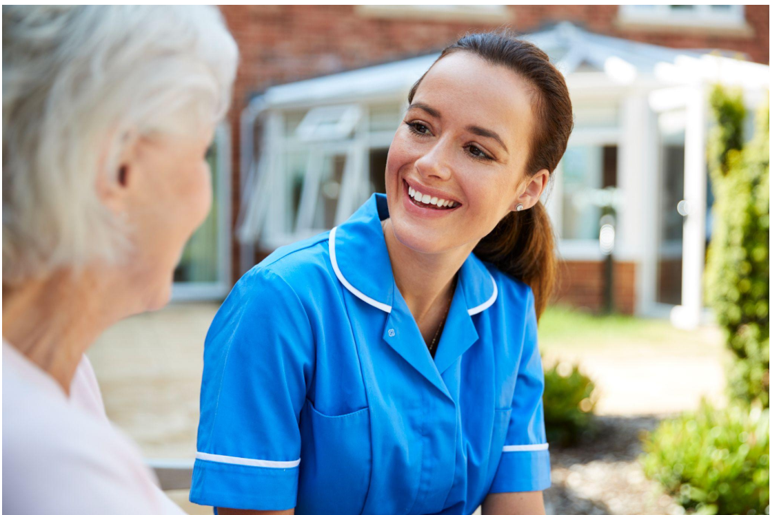 Continuing Care Assistant providing companionship and emotional reassurance to an older adult in a care setting.