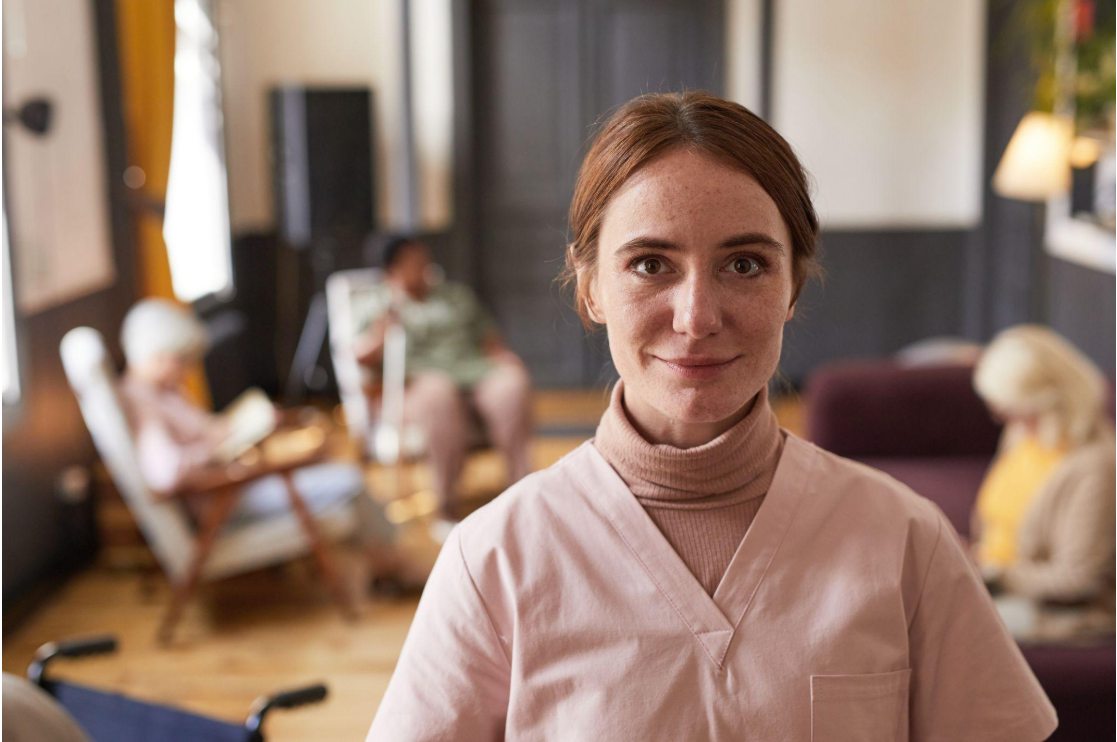 Continuing Care Assistant in a care home setting, representing the human foundation of healthcare through daily hands-on care, comfort, dignity, and safety.