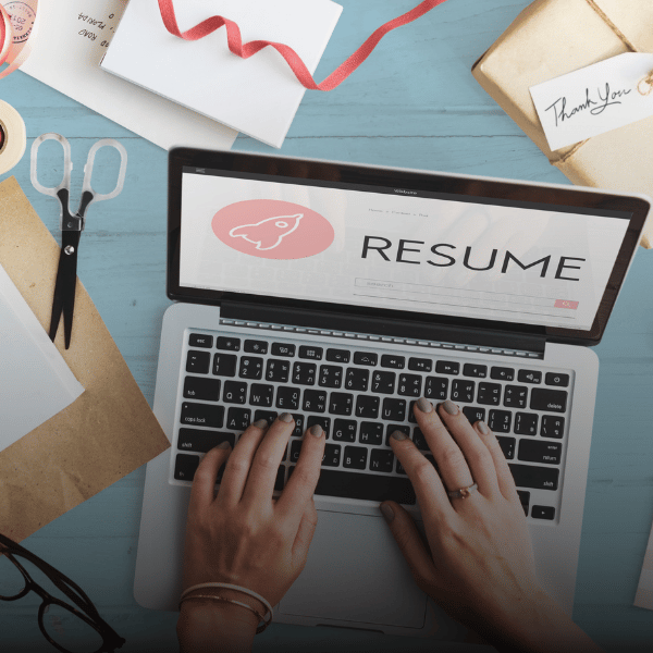 a person typing on the laptop looking for resume support